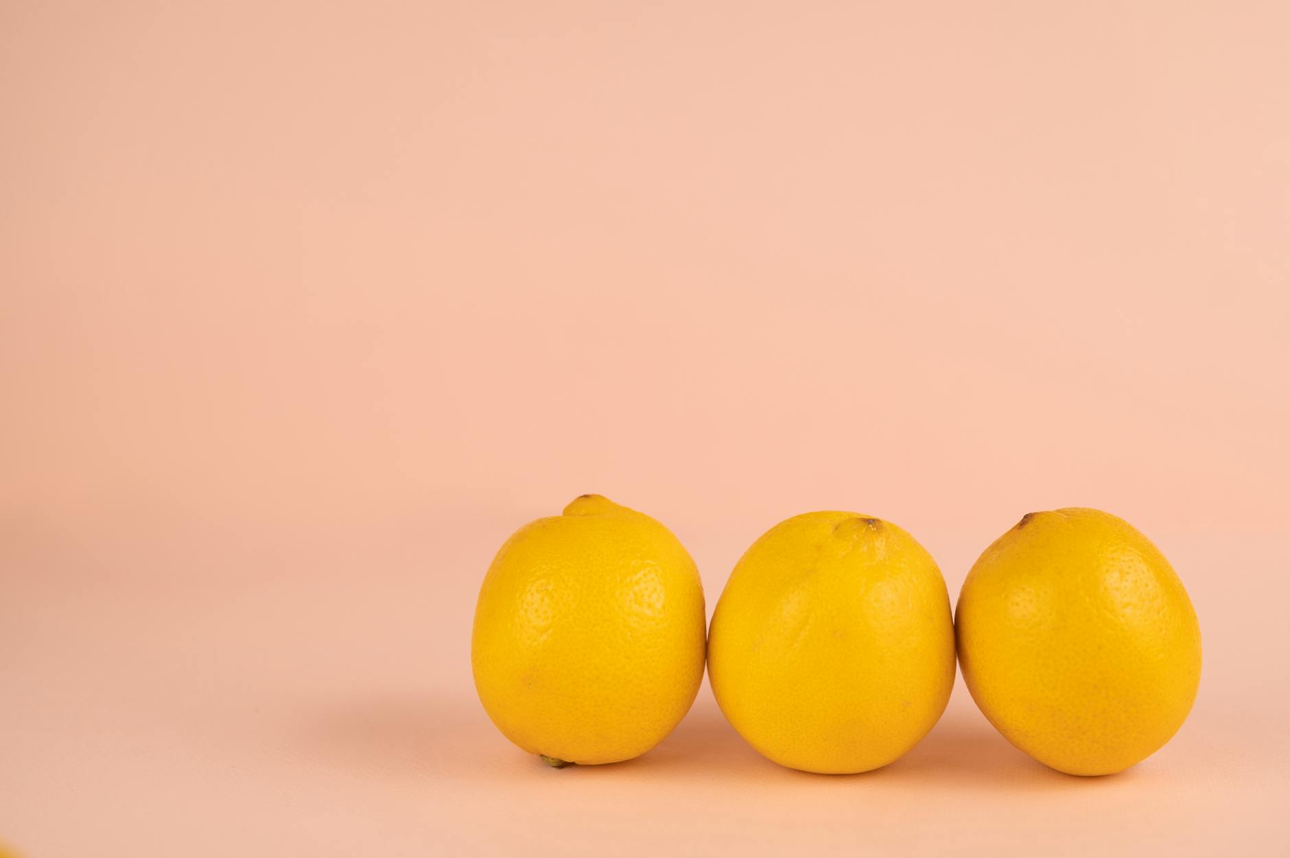 Bright yellow lemons arranged on a pastel background, symbolizing fresh pleasure and clarity